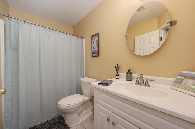 full bath with vanity, toilet, tile patterned floors, a textured ceiling, and visible vents