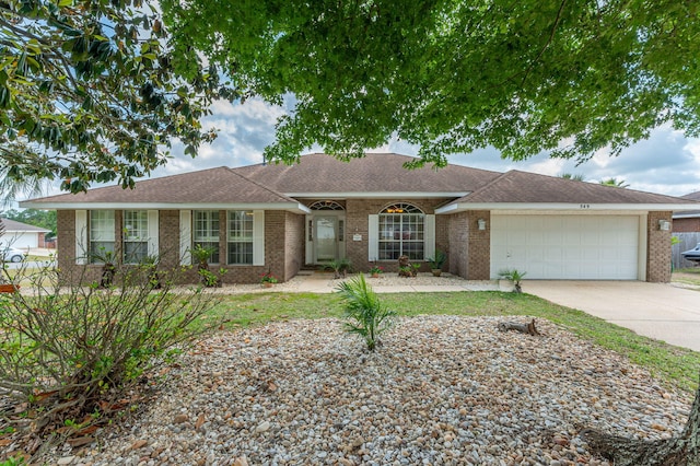 ranch-style home with an attached garage, brick siding, and concrete driveway