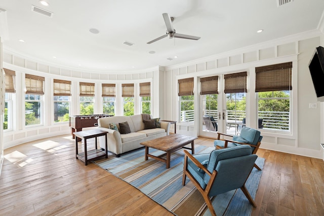 68 Creek Bridge Way, Watersound, FL 32461 - living room featuring a ceiling fan, ornamental molding, a healthy amount of sunlight, and light wood-style floors