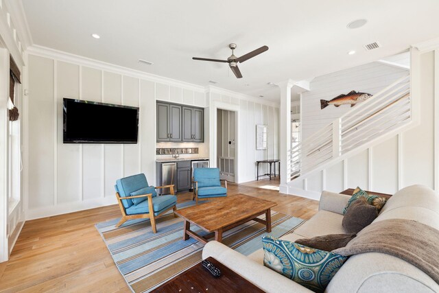 68 Creek Bridge Way, Watersound, FL 32461 - living area featuring crown molding, visible vents, a decorative wall, ceiling fan, and light wood-type flooring