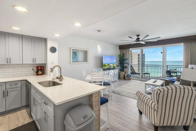 1751 Scenic Highway 98 Unit 906, Destin, FL 32541 - kitchen with a sink, gray cabinets, dishwashing machine, and open floor plan