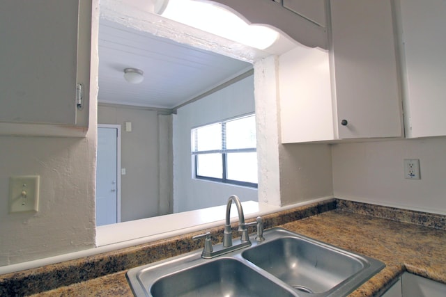 kitchen with a sink and white cabinets