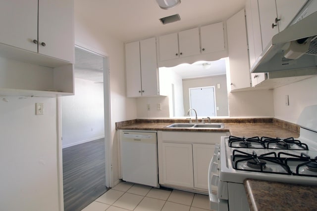 kitchen with white appliances, under cabinet range hood, white cabinets, and a sink