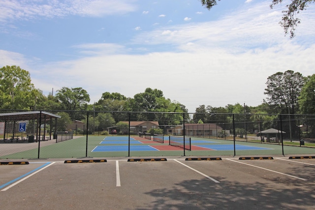view of tennis court featuring fence