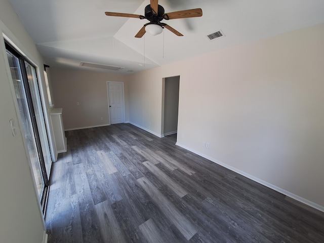 empty room with visible vents, attic access, a ceiling fan, vaulted ceiling, and dark wood-style floors