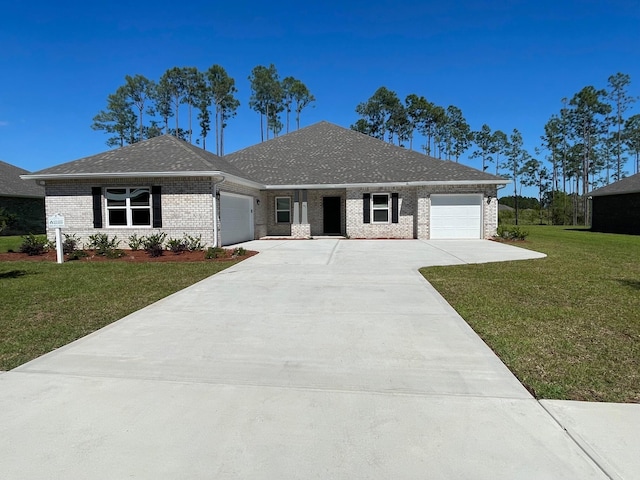 973 Coastal Breeze Dr, Freeport, FL 32439 - ranch-style house featuring brick siding, driveway, a front lawn, and a garage