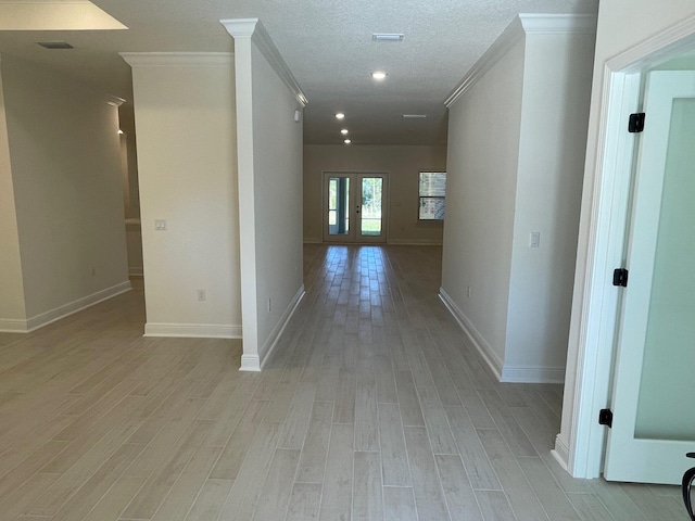 973 Coastal Breeze Dr, Freeport, FL 32439 - corridor featuring light wood-style floors, baseboards, crown molding, and french doors