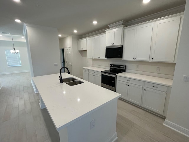 973 Coastal Breeze Dr, Freeport, FL 32439 - kitchen with a sink, an inviting chandelier, light wood-style floors, and stainless steel range with electric stovetop