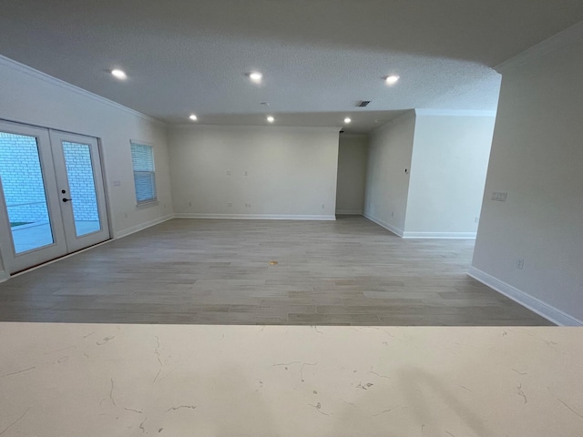 973 Coastal Breeze Dr, Freeport, FL 32439 - unfurnished room featuring french doors, recessed lighting, baseboards, light wood-type flooring, and ornamental molding