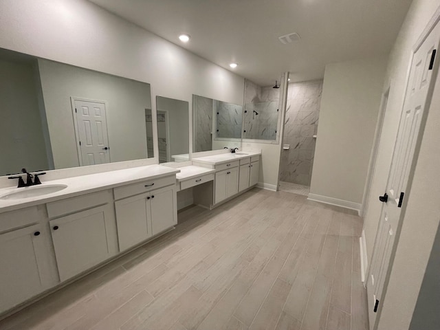 973 Coastal Breeze Dr, Freeport, FL 32439 - bathroom featuring a sink, a marble finish shower, and wood finished floors