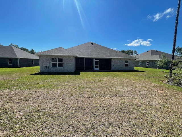973 Coastal Breeze Dr, Freeport, FL 32439 - rear view of property with a sunroom, a yard, and brick siding