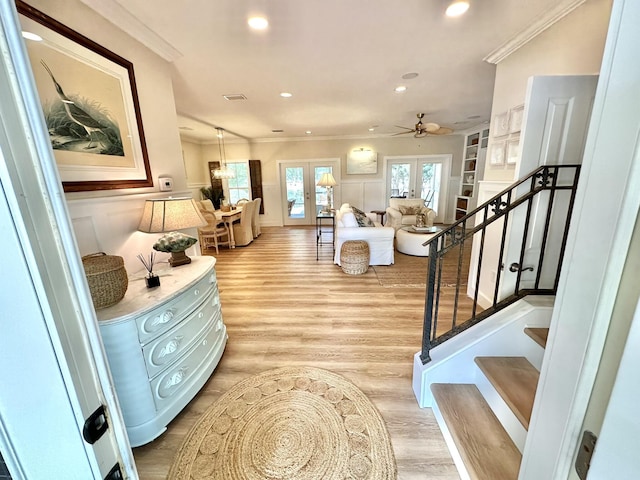 foyer with light wood-style floors, ornamental molding, stairs, recessed lighting, and ceiling fan