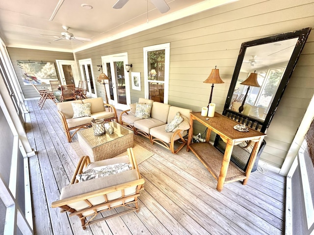 sunroom / solarium featuring a ceiling fan, outdoor lounge area, and french doors
