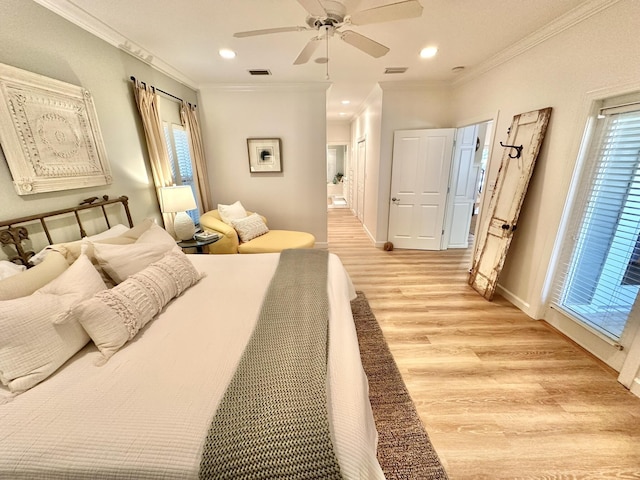 bedroom featuring light wood finished floors, recessed lighting, baseboards, crown molding, and ensuite bathroom