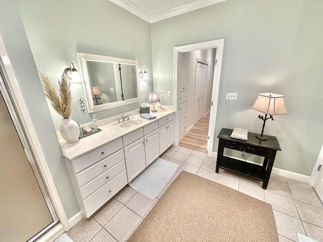 bathroom featuring crown molding, tile patterned flooring, vanity, and baseboards