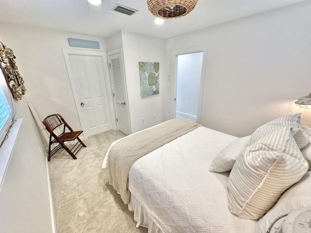 bedroom featuring light carpet and a closet