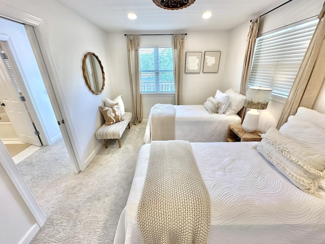 bedroom with light colored carpet, baseboards, and recessed lighting