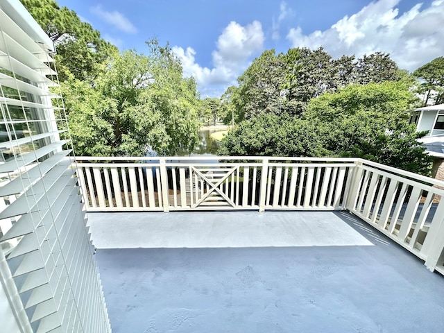 balcony with view of wooded area
