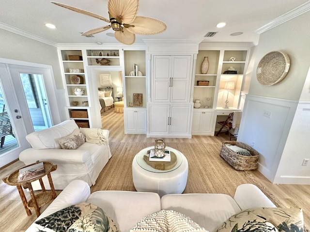 living room featuring light wood-style flooring, ornamental molding, built in shelves, and ceiling fan