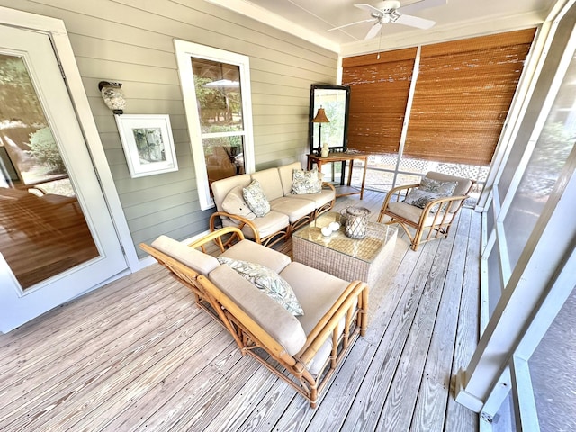 sunroom / solarium with a ceiling fan and an outdoor living space