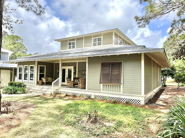 rear view of property with french doors and a yard