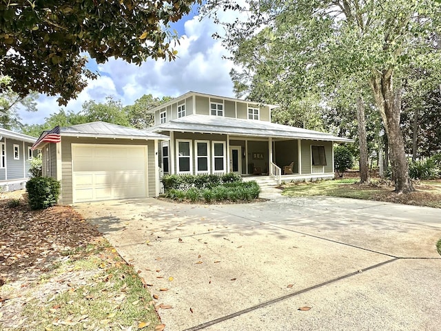 view of front of home featuring a porch, concrete driveway, and an attached garage