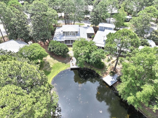 aerial view of property and surrounding area featuring a large body of water and a tree filled landscape