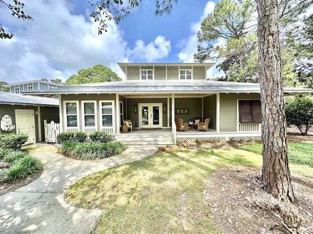 back of property with french doors and covered porch
