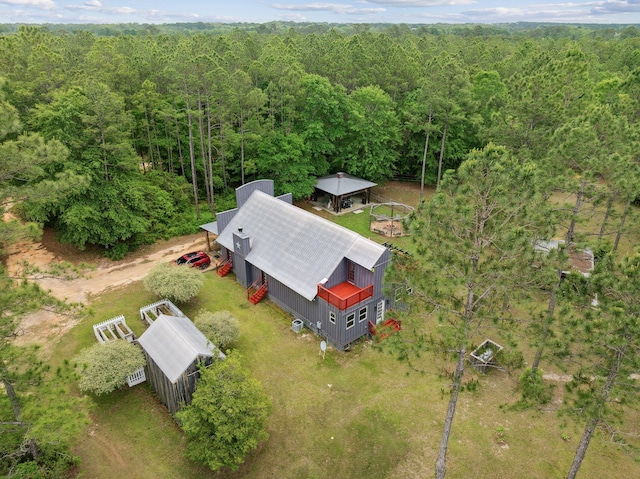 bird's eye view with a wooded view