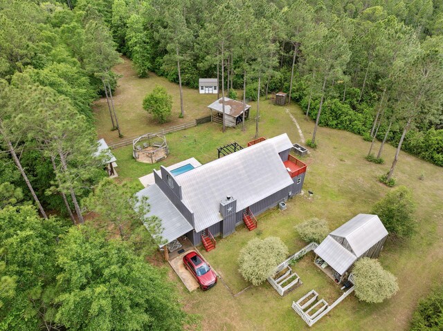 birds eye view of property with a view of trees
