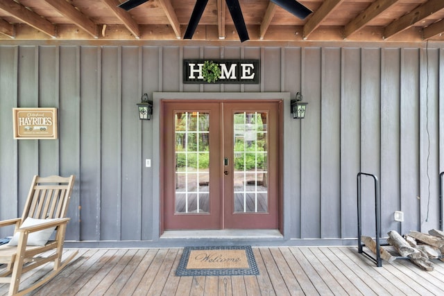 property entrance with board and batten siding and french doors