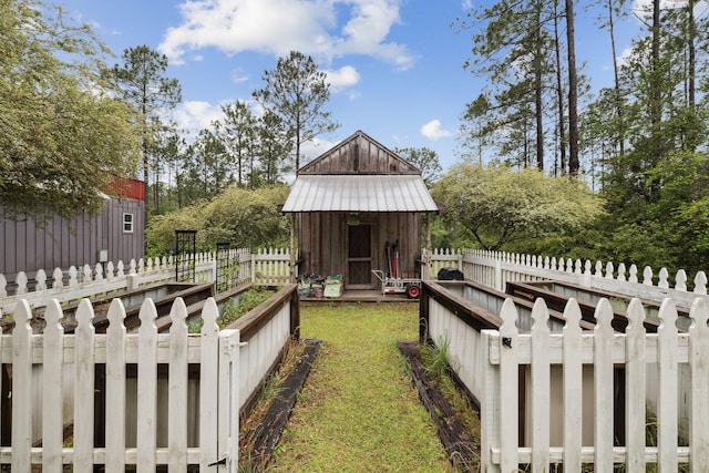 exterior space featuring a storage unit, an outdoor structure, and fence