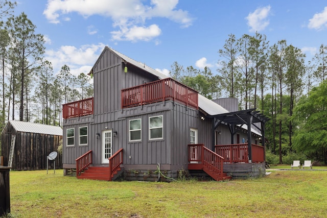 back of house with a lawn, board and batten siding, and a wooden deck