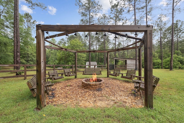 view of yard with fence and an outdoor fire pit