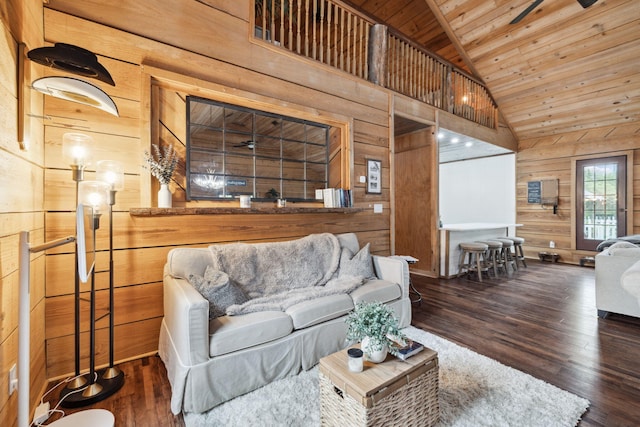 living room with wood walls, wood ceiling, vaulted ceiling, and wood finished floors
