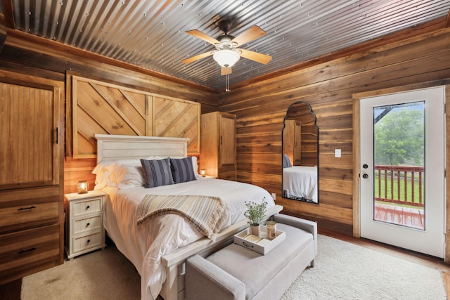 bedroom with wooden ceiling, access to outside, and wood walls