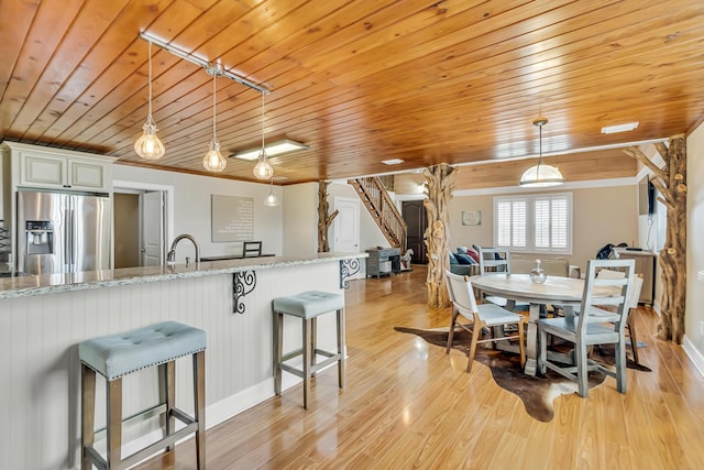 126 Tall Oaks Rd, Defuniak Springs, FL 32435 - dining area featuring light wood-style floors, wood ceiling, and baseboards