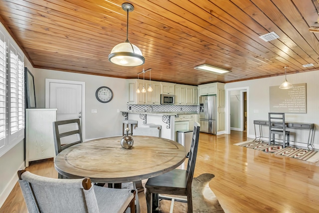126 Tall Oaks Rd, Defuniak Springs, FL 32435 - dining area with crown molding, light wood finished floors, baseboards, visible vents, and wood ceiling