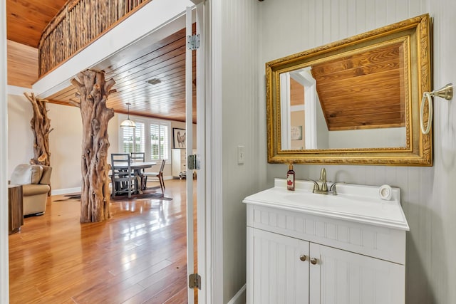 126 Tall Oaks Rd, Defuniak Springs, FL 32435 - bathroom with vanity, wood ceiling, and wood finished floors