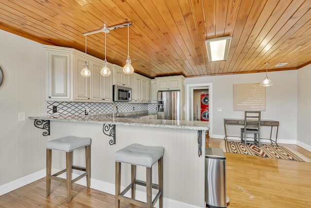 126 Tall Oaks Rd, Defuniak Springs, FL 32435 - kitchen with appliances with stainless steel finishes, a breakfast bar area, a peninsula, ornamental molding, and wood ceiling