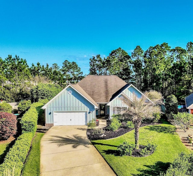 214 Whispering Lake Dr, Santa Rosa Beach, FL 32459 - view of front of property with concrete driveway, board and batten siding, a front yard, and a garage