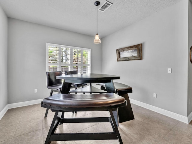 214 Whispering Lake Dr, Santa Rosa Beach, FL 32459 - dining area featuring a textured ceiling, light tile patterned floors, and baseboards