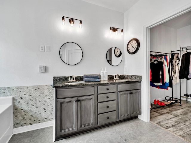 214 Whispering Lake Dr, Santa Rosa Beach, FL 32459 - full bathroom featuring a sink, double vanity, a spacious closet, and wainscoting