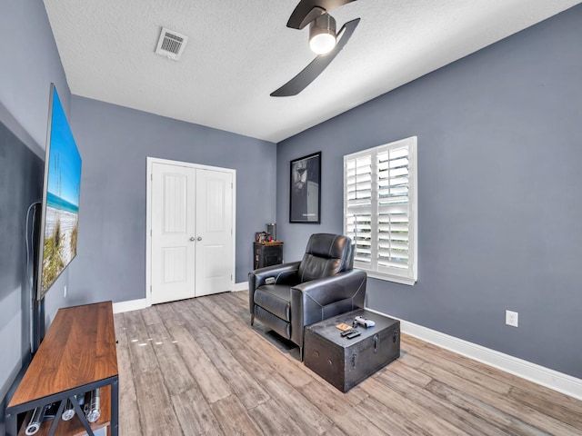 214 Whispering Lake Dr, Santa Rosa Beach, FL 32459 - living area featuring ceiling fan, wood finished floors, baseboards, and a textured ceiling