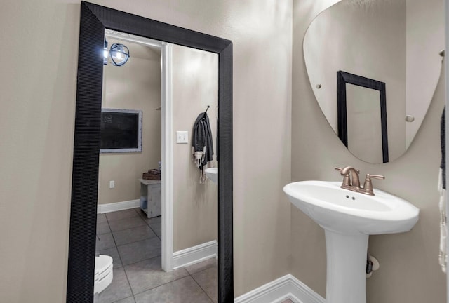214 Whispering Lake Dr, Santa Rosa Beach, FL 32459 - bathroom featuring tile patterned flooring, baseboards, and a sink