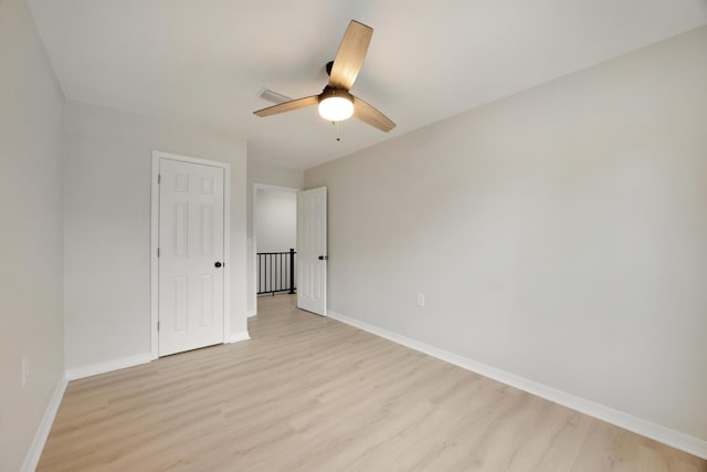 unfurnished bedroom with light wood-style floors, baseboards, and visible vents