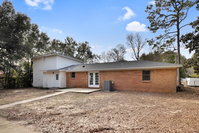 rear view of house featuring french doors, central AC unit, a patio, and brick siding