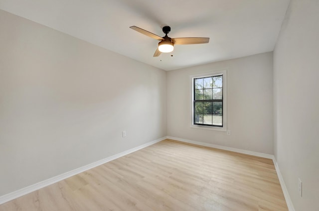 empty room with light wood-style floors, baseboards, and a ceiling fan