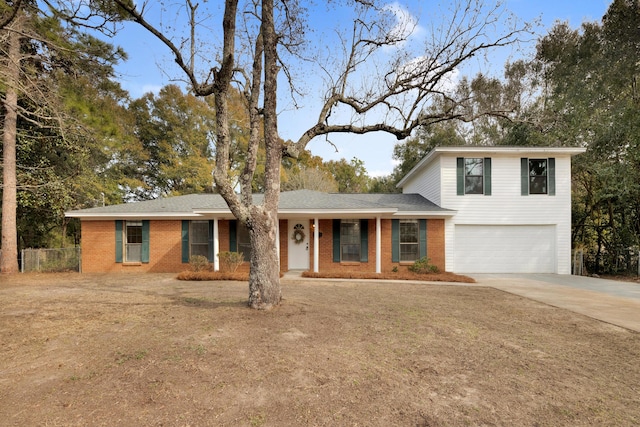 view of front of home featuring fence, brick siding, concrete driveway, an attached garage, and a porch