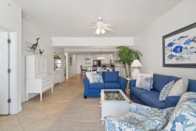 living area with a ceiling fan and light tile patterned floors